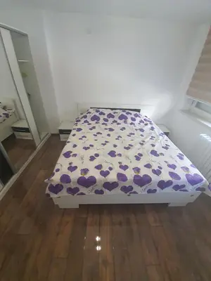 a bed with a purple bedspread with hearts on it at Apartment City Centar in Banja Luka