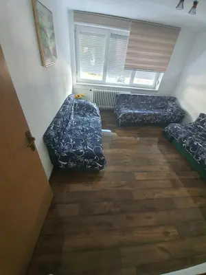 a room with three beds and a window at Apartment City Centar in Banja Luka