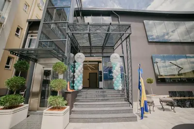 a building with a staircase with blue and white balloons at Hotel Vertigos in Tuzla