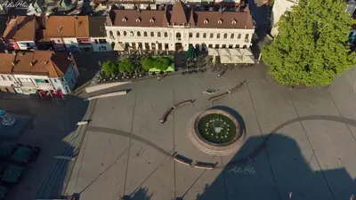 an overhead view of a large building with a clock at Hotel Vertigos in Tuzla