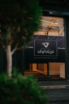 a building with a sign on the front of it at Hotel Vertigos in Tuzla