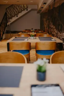 a row of tables and chairs in a restaurant at Hotel Vertigos in Tuzla