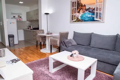 a living room with a couch and a table at Apartman Royal 2 in Doboj