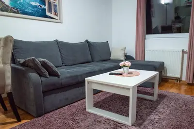 a living room with a couch and a table at Apartman Royal 2 in Doboj