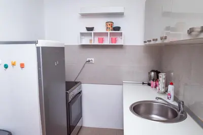 a small kitchen with a sink and a refrigerator at Apartman Royal 2 in Doboj