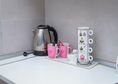 a counter with cups and a coffee maker on it at Apartman Royal 2 in Doboj