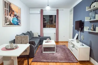 a living room with a couch and a table at Apartman Royal 2 in Doboj