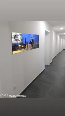 a white hallway with a picture on a wall at Gold Apartmani Kozarac in Kozarac