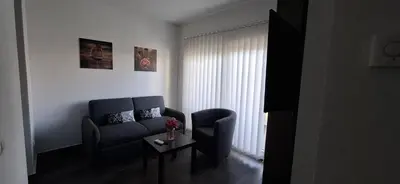 a living room with a couch and a table at Gold Apartmani Kozarac in Kozarac