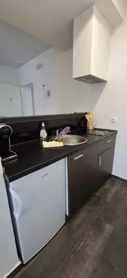 a kitchen with a sink and a counter top at Gold Apartmani Kozarac in Kozarac