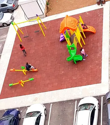 a group of people playing on a playground at Apartman Istra, Doboj in Doboj