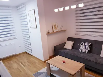 a living room with a couch and a coffee table at Apartman Istra, Doboj in Doboj