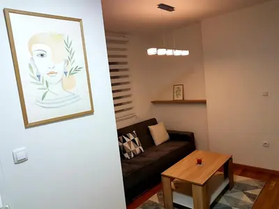 a living room with a couch and a table at Apartman Istra, Doboj in Doboj