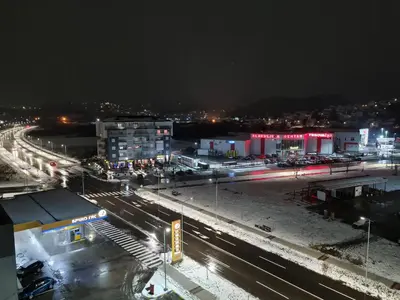 a city at night with traffic on the street at Apartman Istra, Doboj in Doboj