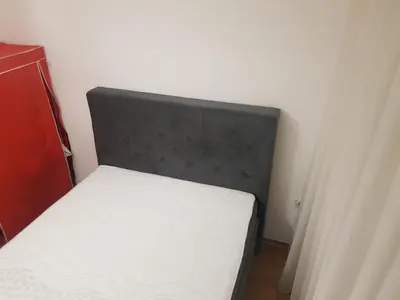 a bed with a black headboard in a room at Apartman Casa Banja Luka in Banja Luka