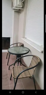 a table and two chairs sitting next to a window at Apartman Casa Banja Luka in Banja Luka