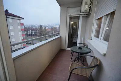 a balcony with two chairs and a table on it at Apartman Casa Banja Luka in Banja Luka