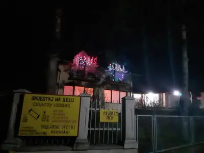 a building with christmas lights on top of it at Smještaj na selu,porodica Gvozdenac in Šipovo