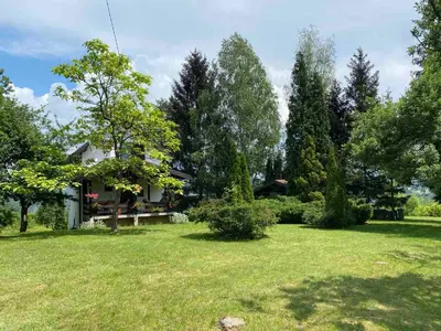 a house in a yard with trees and grass at PURE NATURE in Visoko