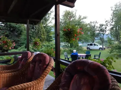 a porch with chairs and a view of a yard at PURE NATURE in Visoko