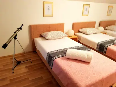 a room with two beds and a camera on a tripod at My Eden Bihać in Mahala