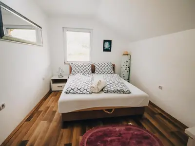 a bedroom with a bed and a window at My Eden Bihać in Mahala