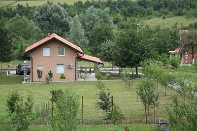 a house in the middle of a field with trees at My Eden Bihać in Mahala
