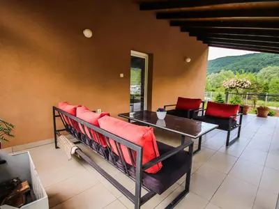 a dining room with red cushioned chairs and a table at My Eden Bihać in Mahala