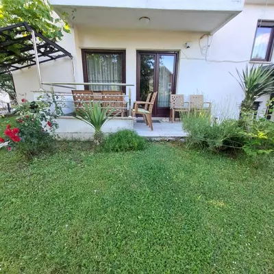 a porch of a house with a bench and plants at Villa Behić in Bihać