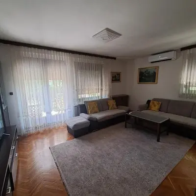 a living room with a couch and a table at Villa Behić in Bihać