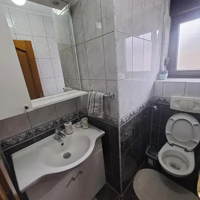 a bathroom with a sink and a toilet at Villa Behić in Bihać