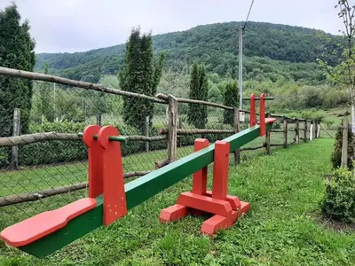 a row of benches in front of a fence at Wooden House Ripac in Bihać