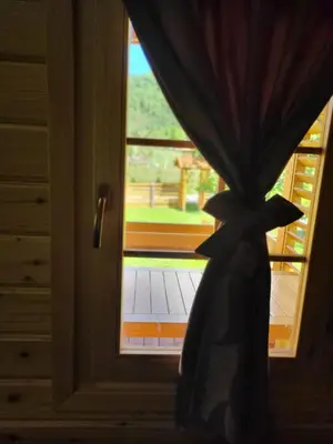 a curtain in front of a door with a window at Wooden House Ripac in Bihać
