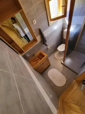 an overhead view of a bathroom with a toilet and a mirror at Wooden House Ripac in Bihać