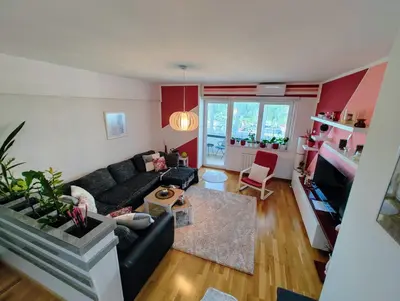 an overhead view of a living room with a black couch at Best Location - Heart Of Tuzla in Tuzla