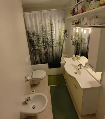 a bathroom with two sinks and a toilet and a window at Best Location - Heart Of Tuzla in Tuzla