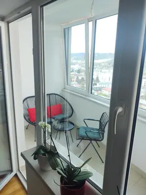 a room with chairs and a table with windows at Best Location - Heart Of Tuzla in Tuzla