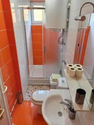 a bathroom with a sink and a shower and a toilet at Apartman Banja Luka 2 in Banja Luka
