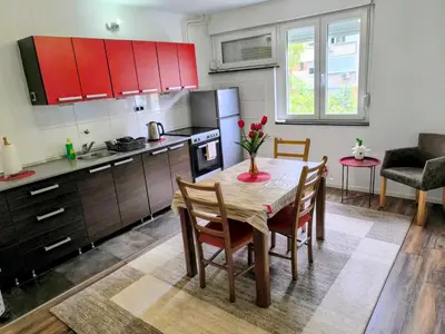 a kitchen and dining room with a table and chairs at Apartman Banja Luka 2 in Banja Luka