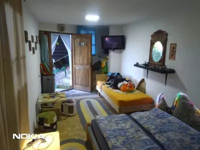 a living room with two beds and a tv at Apartment STONE in Visoko