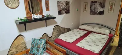 a bedroom with a bed and a table and chairs at Apartment STONE in Visoko