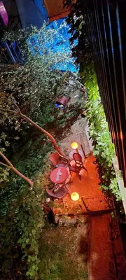 an overhead view of a table with chairs and lights at Apartment STONE in Visoko