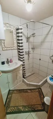a bathroom with a shower and a sink at Apartment STONE in Visoko