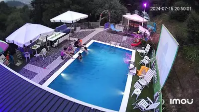 an overhead view of a swimming pool with people sitting around it at Apartment STONE in Visoko