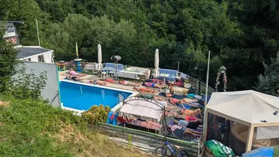 a boat with people laying around a swimming pool at Apartment STONE in Visoko