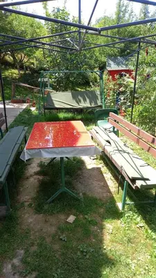 a picnic table and two benches in a park at Medena oaza mira in Visoko