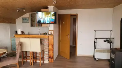 a living room with a television on the wall at Medena oaza mira in Visoko