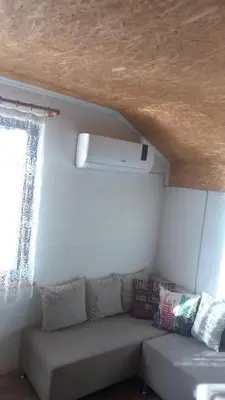 a living room with a couch and a window at Medena oaza mira in Visoko