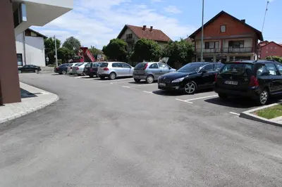 a row of cars parked in a parking lot at Apartman Lilly in Modriča