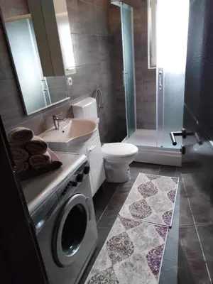 a bathroom with a washing machine and a sink at apartman Vidović in Livno